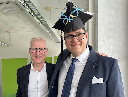 Mo Kari with his doctoral advisor, while Mo wears a PhD graduation hat